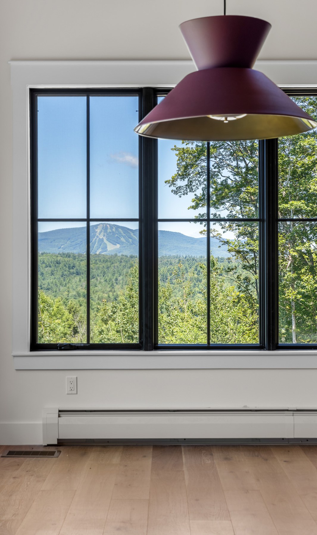 Vermont Green Mountains seen through a window with a pendant light